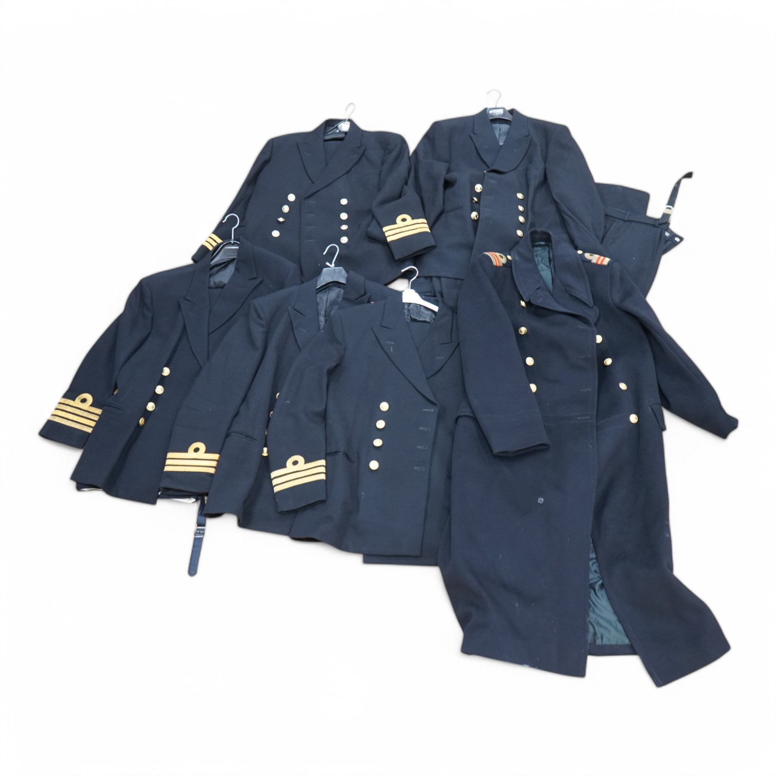 A Royal Navy officer's great coat, cap and four other Navy Officer's jackets. Condition - fair/good